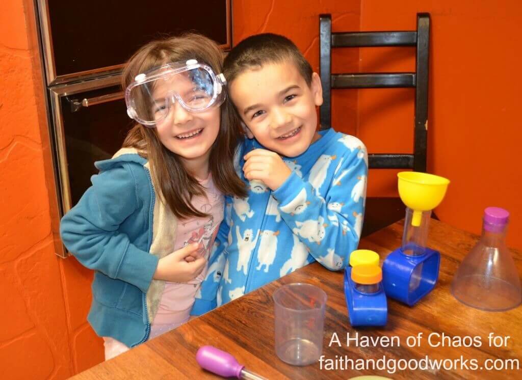 Sarah's daugther, 7 yrs. old, and son, 6 yrs. old, posing next to their science kit.